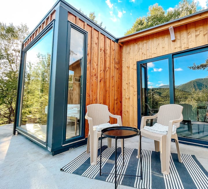 elevated tiny house, Transylvanian hill views, secluded retreat, cozy comforts, outdoor relaxation, hot tub experience, communal spaces, pet-friendly property, unique vantage point, nature immersion, culinary delights.